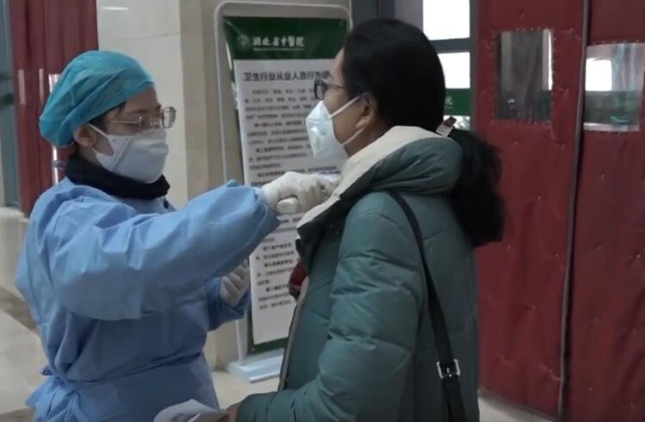 a-nurse-measuring-the-body-temperature-for-outpatients-in-hubei-tcm-hospital.jpg